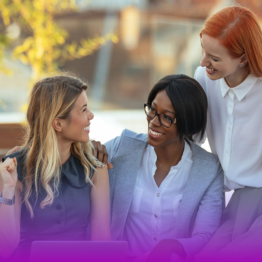 Three woman looking at a computer