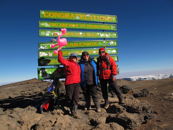 Emilie with two of her clients at the summit of Kilimanjaro in September 2013
